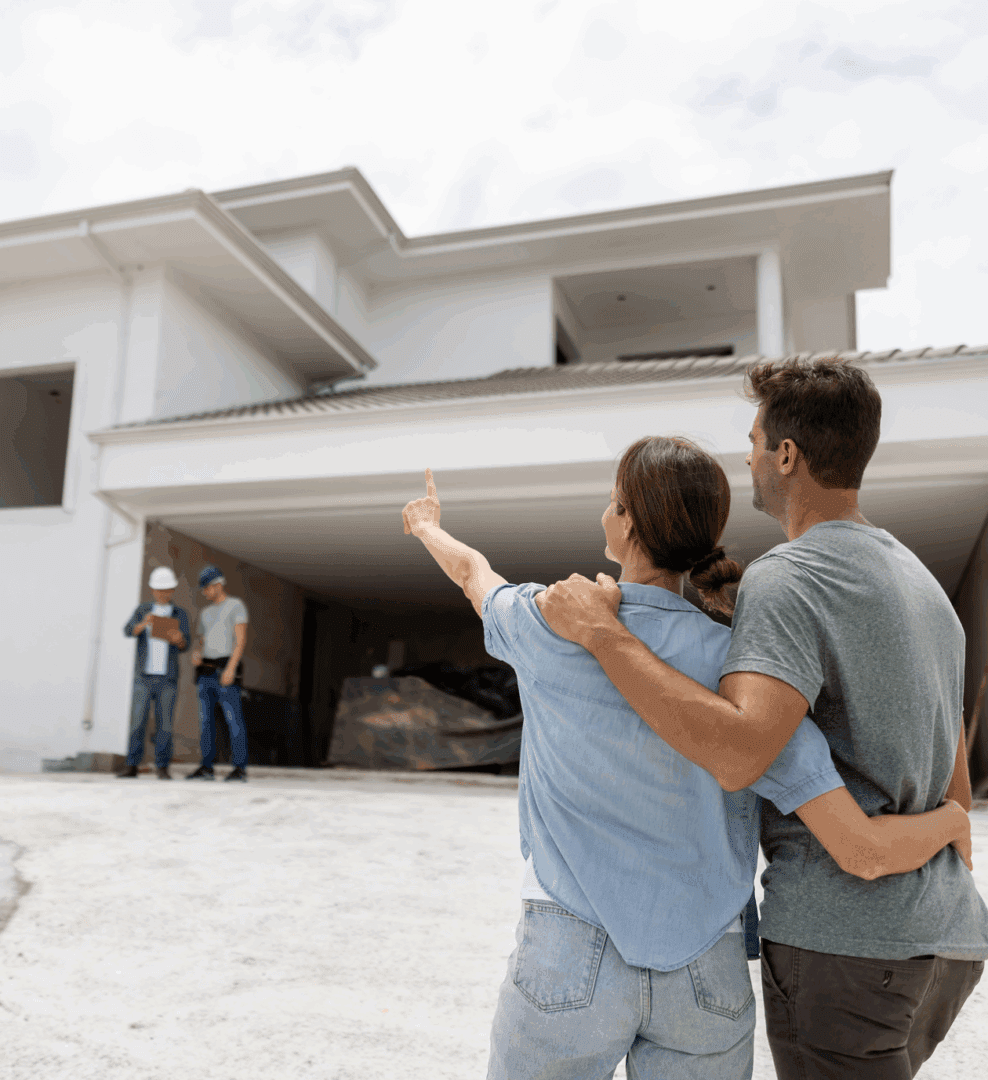 Couple looking at new house under construction.