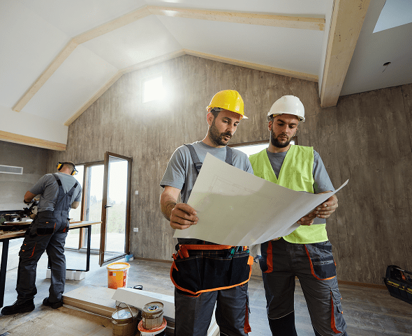 Workers discussing project details at construction site