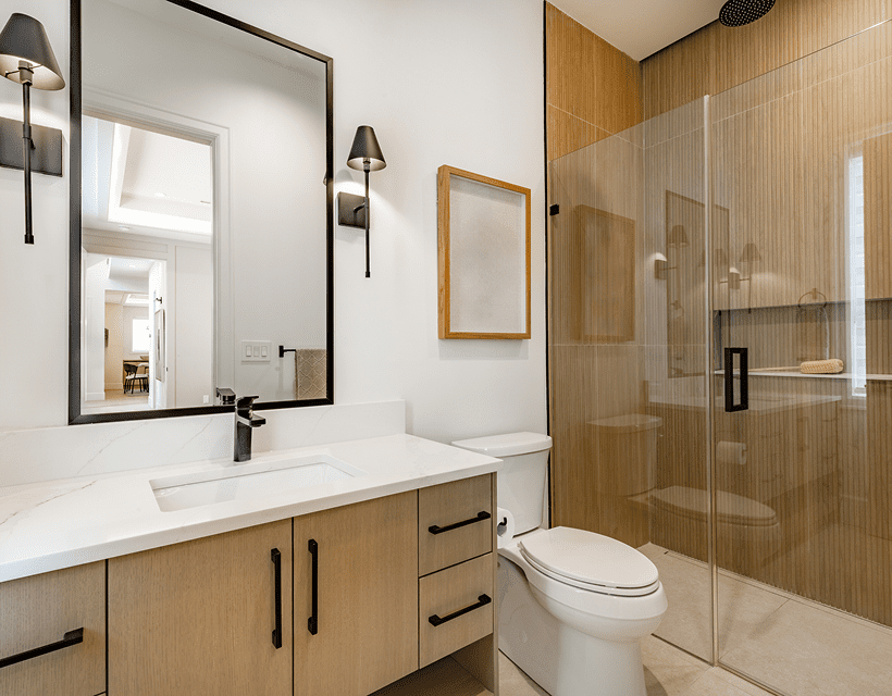 Modern bathroom with wooden accents and shower.