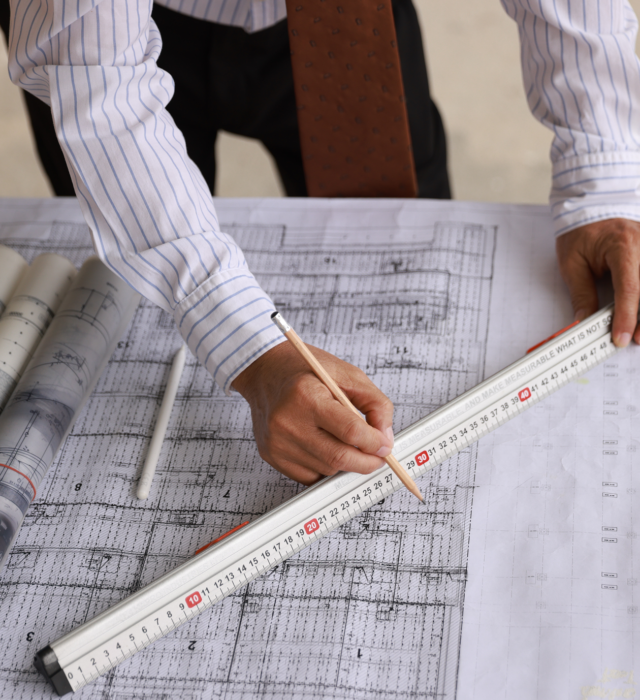 Architect measuring blueprints with a ruler
