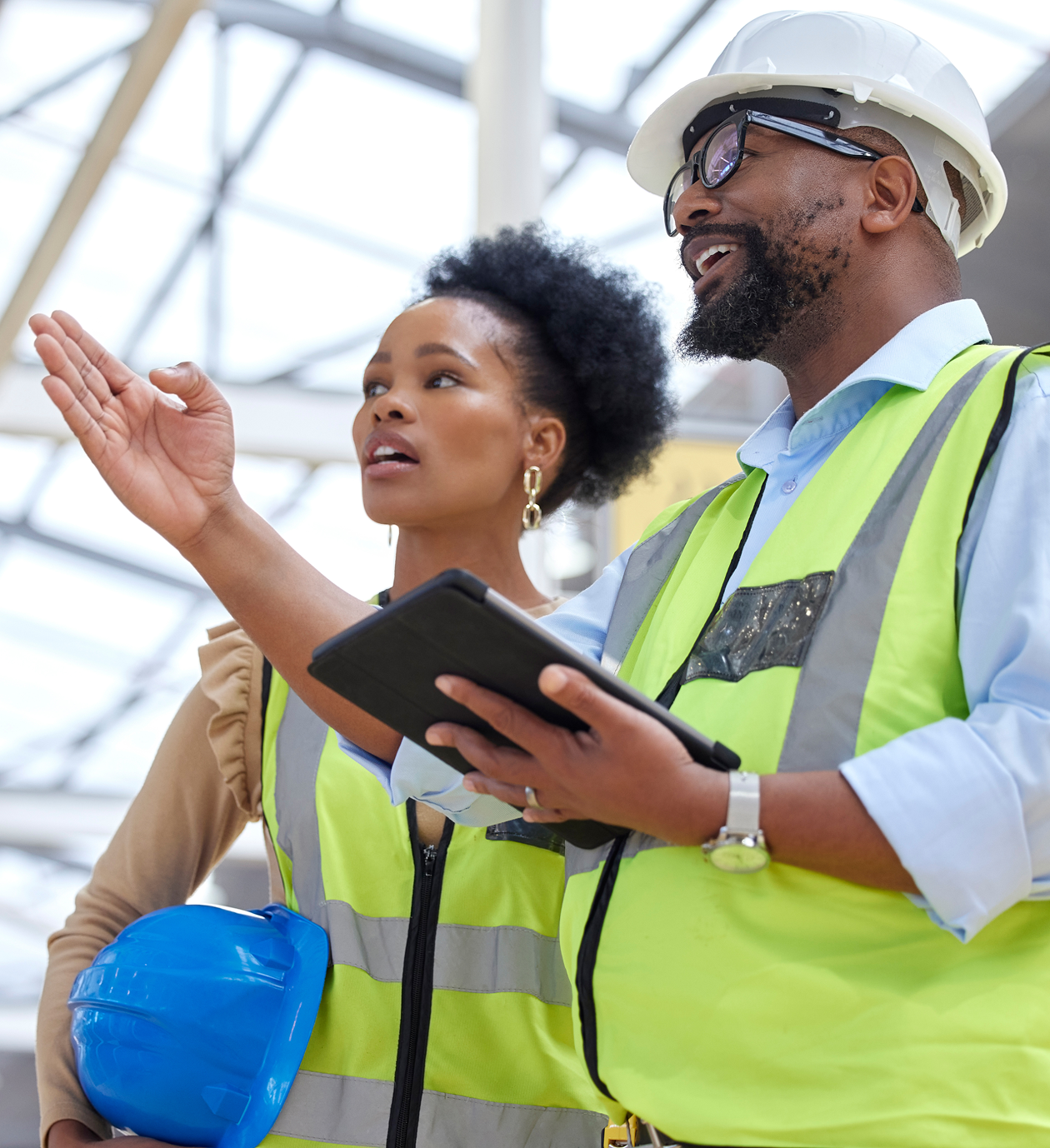 Construction workers discussing site plans indoors.